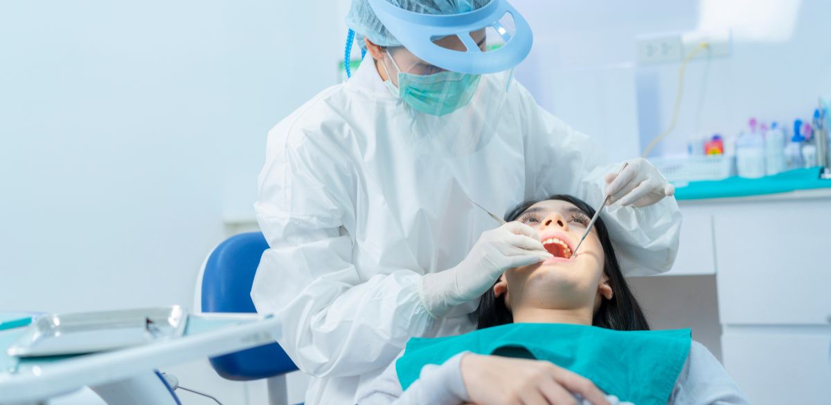 dentist performing a routine dental cleaning on a patient in a street dental