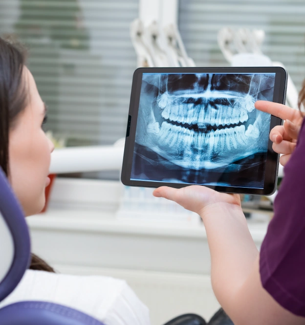 Dentist showing x ray to a patient