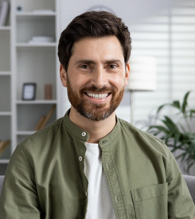 A man smiling in an indoor setting